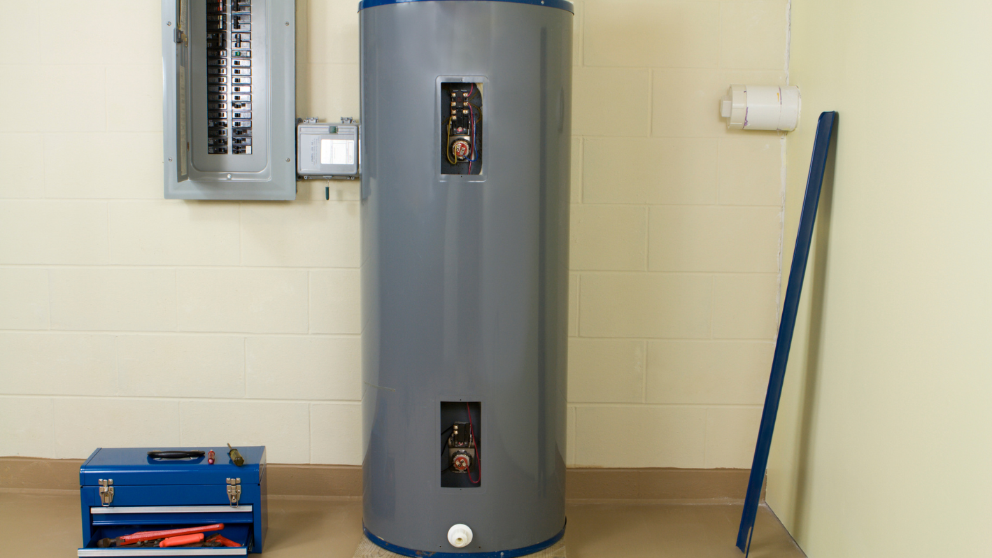 A water heater sitting in a room next to a wall